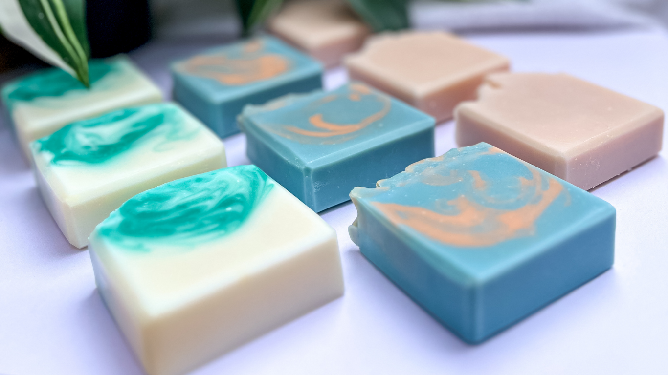Assorted colored soap bars on a white surface